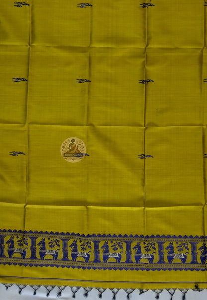 Close-up of pure silk fabric of Baluchari stole – warm mustard weave with delicate hand-woven buti motifs, naturally lustrous handloom silk from Bishnupur, West Bengal