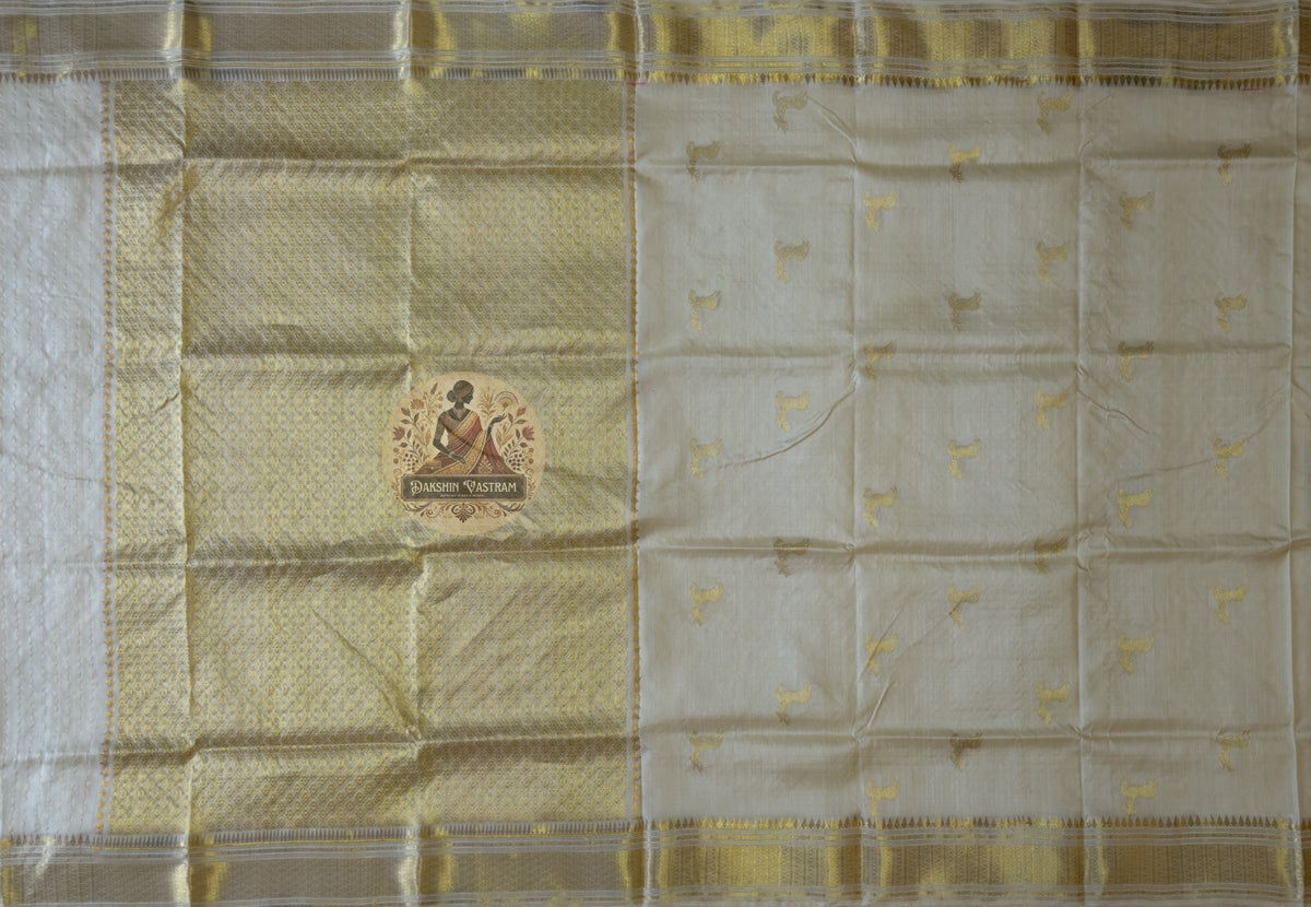 Full flat lay of Chhattisgarh Tussar silk saree showing natural forest gold body, woven-in traditional border and wild silk texture — quiet confidence collection, Dakshin Vastram