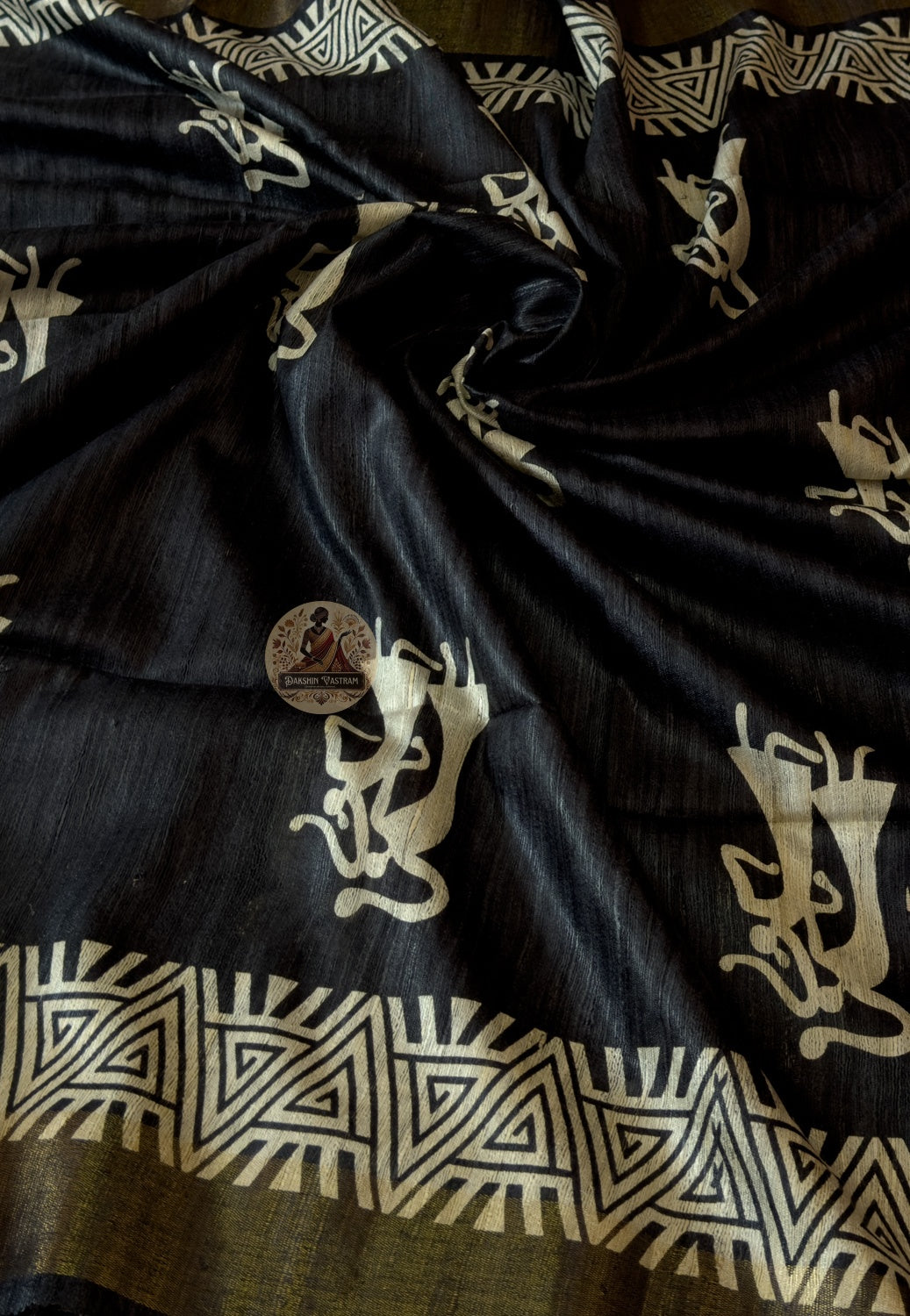 Close-up of Ghicha Tussar Silk weave revealing natural irregular fibres, warm sand lustre and handloom depth — no dye, no machine, just wild silk and skilled hands creating something irreplaceable