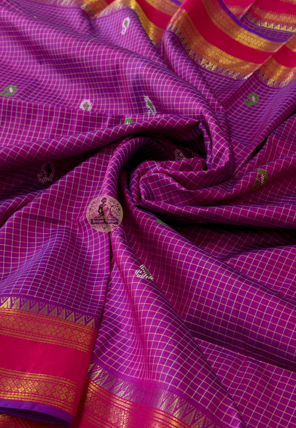 Close-up of Bishnupuri handwoven katan silk weave – warm natural silk lustre amplifying the wearer's beauty, intricate Bengal temple motifs woven permanently into pure silk
