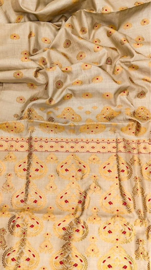 Close-up of handwoven Muga silk fabric showing natural golden sheen and traditional Assamese weave pattern