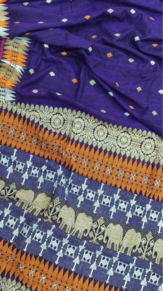 Indian woman in full drape of pure Eri silk handloom saree, 650g substantial weave, warm matte finish, traditional Assamese craft