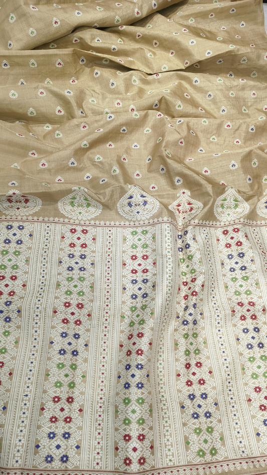 Close-up of aged Muga silk weave showing naturally deepening golden oxidised thread and fine handloom density — Assam heirloom craftsmanship