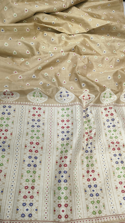 Woman in a naturally golden Muga silk handloom saree styled for a silver wedding anniversary celebration — Dakshin Vastram heirloom collection UK
