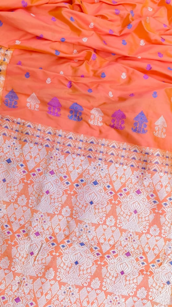 Traditional Assamese woven border detail on pure Mulberry Silk saree, intricate river folklore motif