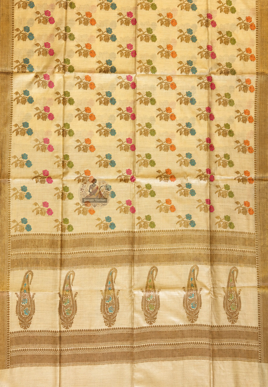 Close-up of fine Banarasi zari work on Muga Tussar Saree showing handwoven gold thread motifs of lotus and geometric jaal on natural golden silk