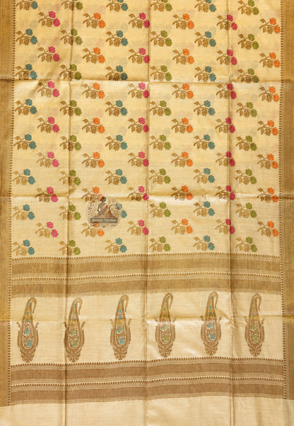 Close-up of fine Banarasi zari work on Muga Tussar Saree showing handwoven gold thread motifs of lotus and geometric jaal on natural golden silk