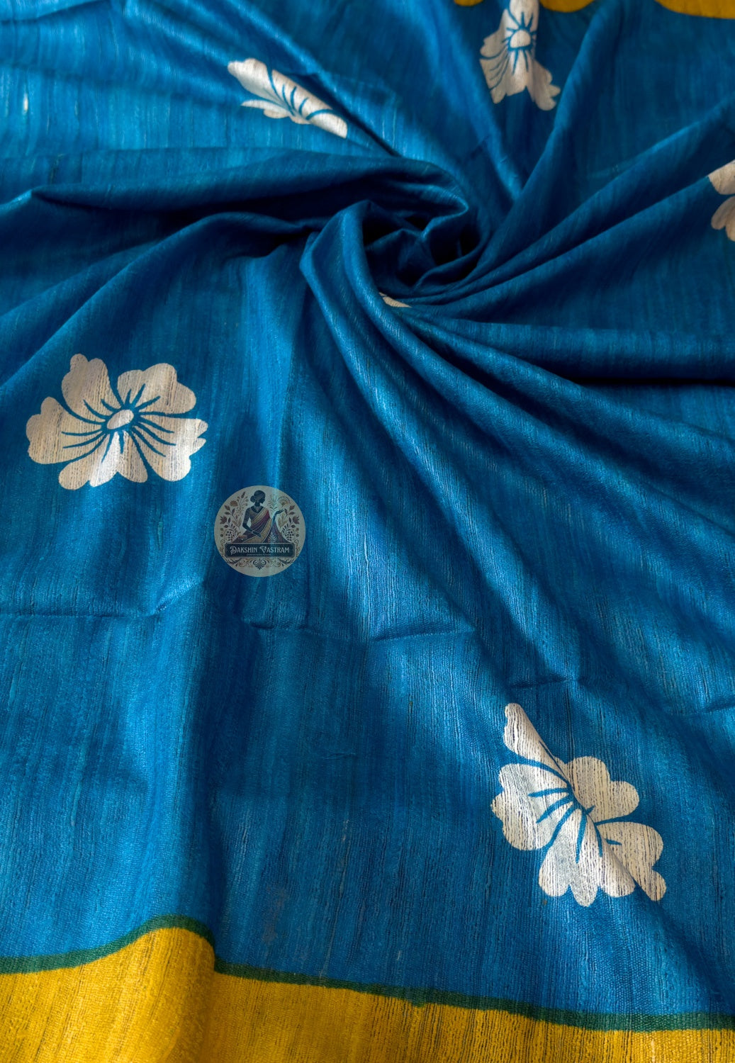 Close-up of Ghicha Tussar Silk weave showing short-staple raw silk threads, natural golden-brown tone and tactile handloom texture — woven one thread at a time by skilled artisans