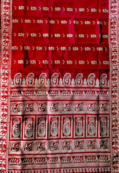 Close-up of Bishnupur maroon Baluchari silk saree weave revealing finely woven mythological figures and floral border on deep maroon silk
