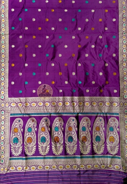Close-up of Bishnupur Baluchari prestige silk saree weave showing master-woven mythological figures and ornate border formed thread by thread in pure silk