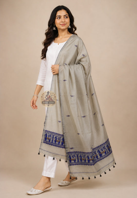Front view of handwoven Baluchari silk stole in stone grey – pure silk with royal blue narrative border and black tassels draped over white kurta – Dakshin Vastram