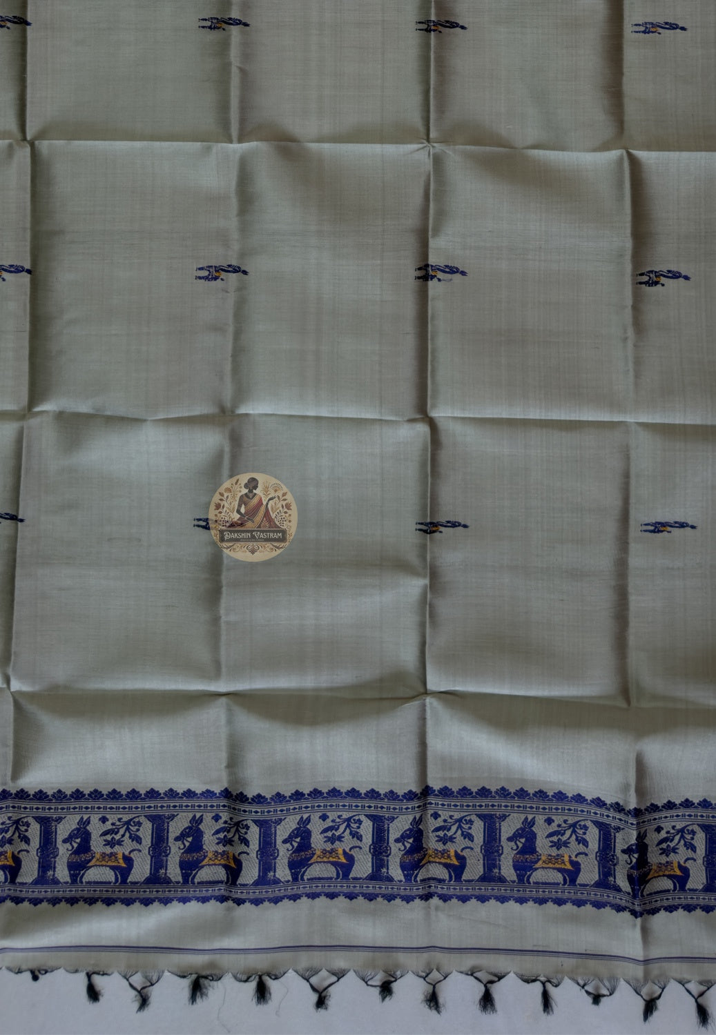 Close-up of pure silk fabric of Baluchari stole – warm stone grey weave with delicate hand-woven buti motifs, naturally lustrous handloom silk from Bishnupur, West Bengal