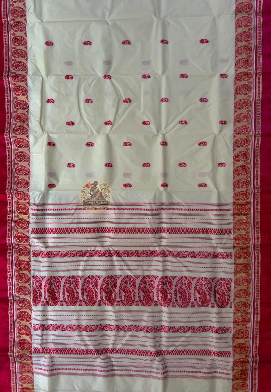 Close-up of Bishnupur Garad silk saree weave showing warm natural ivory mulberry silk texture with subtle buti motifs visible in natural light