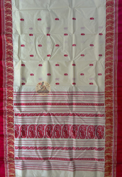 Close-up of Bishnupur Garad silk saree weave showing warm natural ivory mulberry silk texture with subtle buti motifs visible in natural light