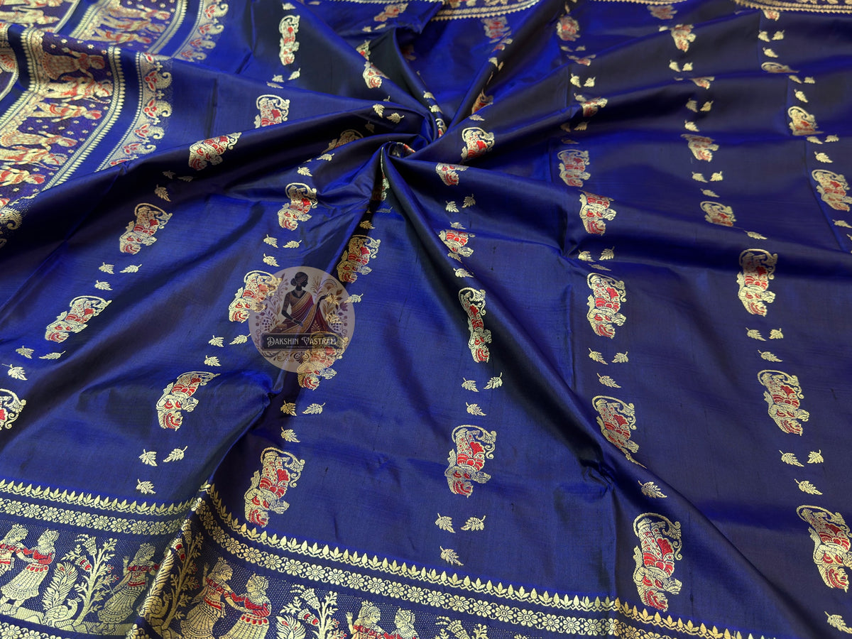 Lustrous teal Baluchari silk saree with uncut zari border and woven figurative motifs on pallu