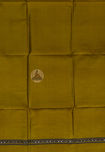 Detail shot of woven Baluchari border motifs on mustard yellow silk kurti fabric — artisan handcrafted textile from Bishnupur