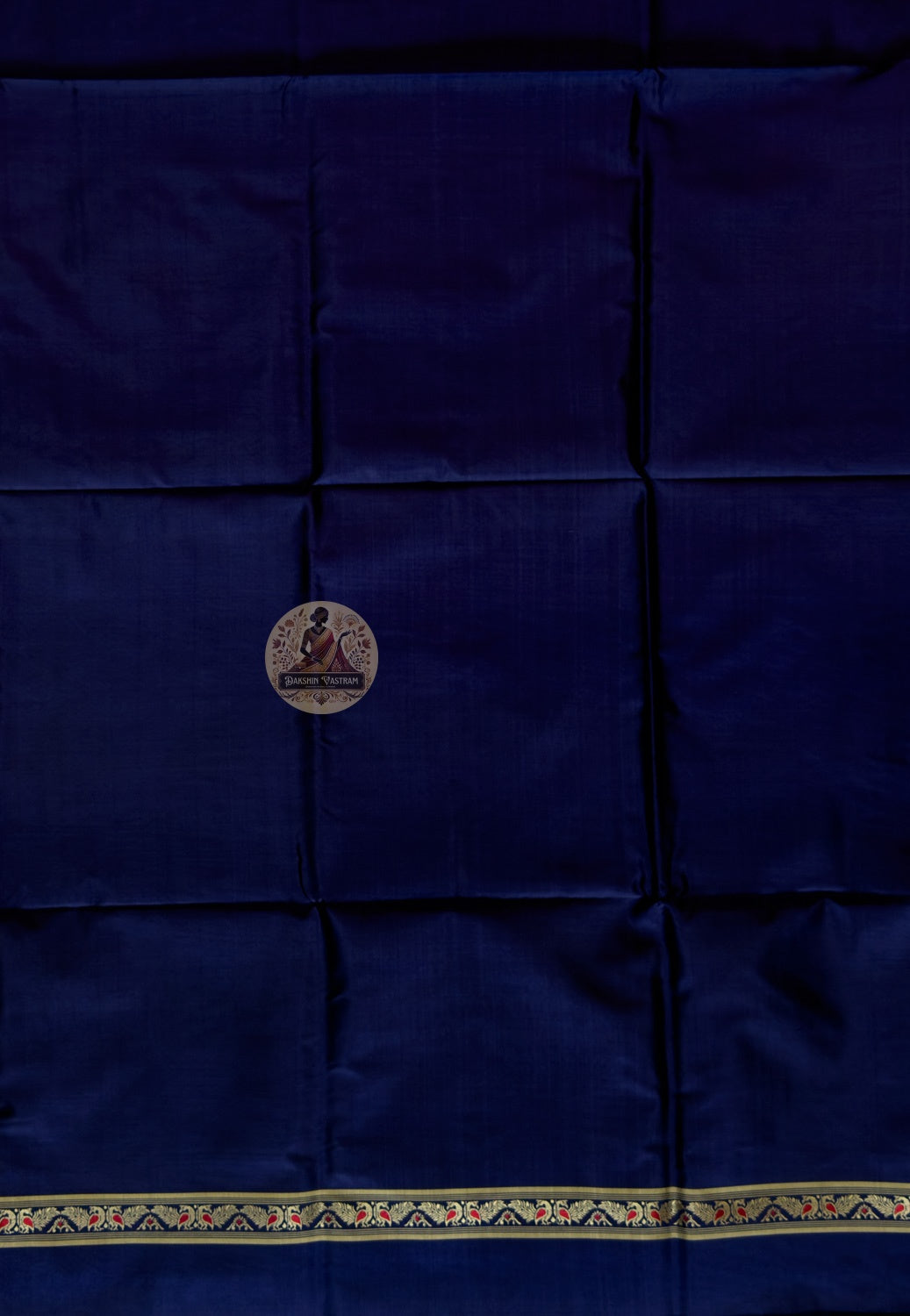 Detail shot of woven Baluchari border motifs on deep blue silk kurti fabric — artisan handcrafted textile from Bishnupur