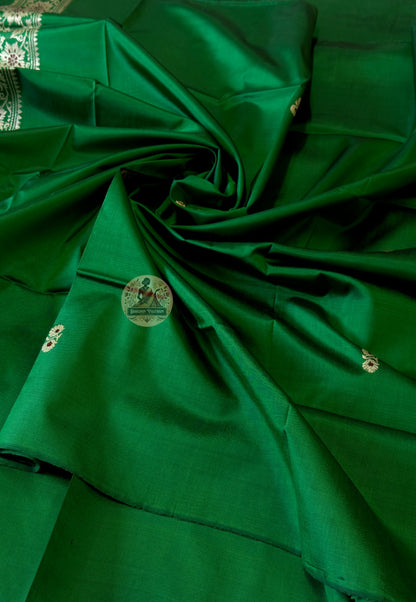 Detail of traditional Baluchari woven border motifs on verdant green silk kurti fabric — artisan textile from Bishnupur
