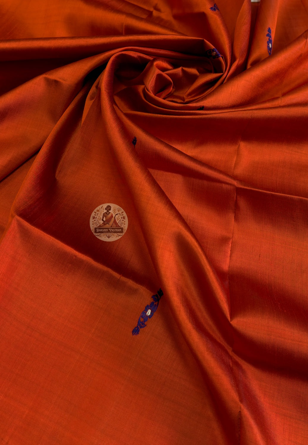 Close-up of pure silk fabric of Baluchari stole – warm brick red weave with delicate hand-woven buti motifs, naturally lustrous handloom silk from Bishnupur, West Bengal