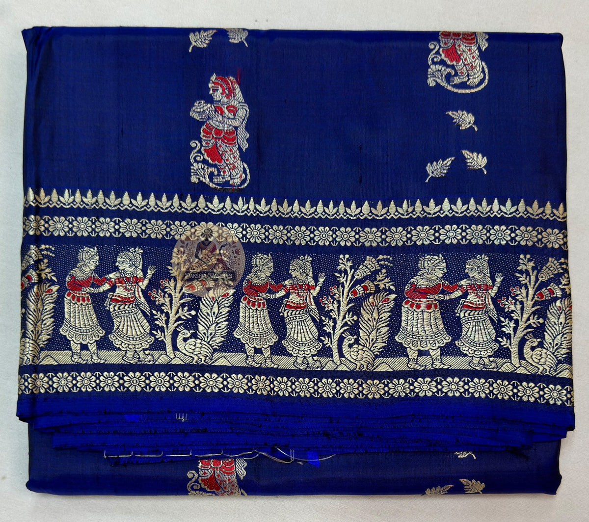 Close-up of pure silk fabric of Bishnupur Baluchari Saree showing natural lustrous sheen and fine handwoven texture of traditional Bengal silk